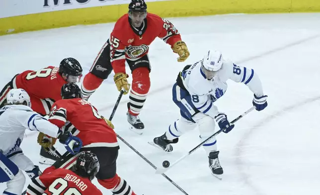 Toronto Maple Leafs right wing William Nylander (88) moves the puck against the Chicago Blackhawks during the second period of an NHL hockey game, Sunday, Feb. 23, 2025, in Chicago. (AP Photo/Matt Marton)