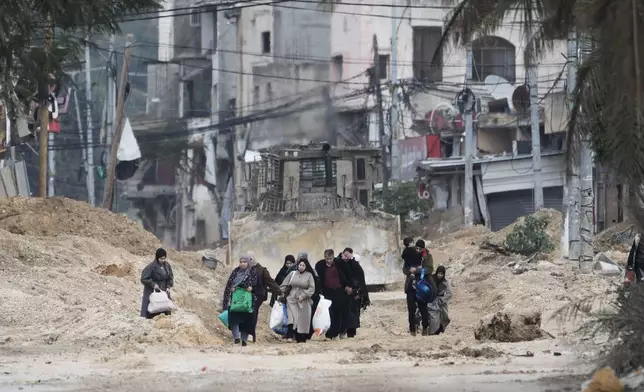 Residents of the West Bank refugee camp of Nur Shams, Tulkarem, evacuate their homes as the Israeli military continues its operation in the area on Tuesday, Feb. 11, 2025. (AP Photo/Majdi Mohammed)