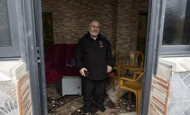 Mohammed Shula poses for a photo inside a relative's house where he and his wife have taken refuge at the West Bank village of Kafr al-Labad, Monday, Feb. 10, 2025. (AP Photo/Nasser Nasser)