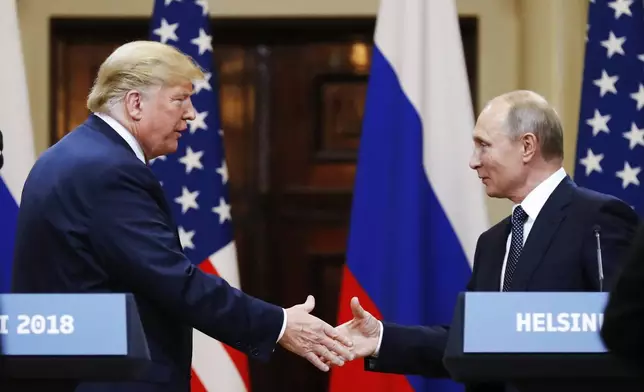 FILE - In this file photo taken on Monday, July 16, 2018, U.S. President Donald Trump shakes hand with Russian President Vladimir Putin at the end of the press conference after their meeting at the Presidential Palace in Helsinki, Finland. (AP Photo/Alexander Zemlianichenko, File)