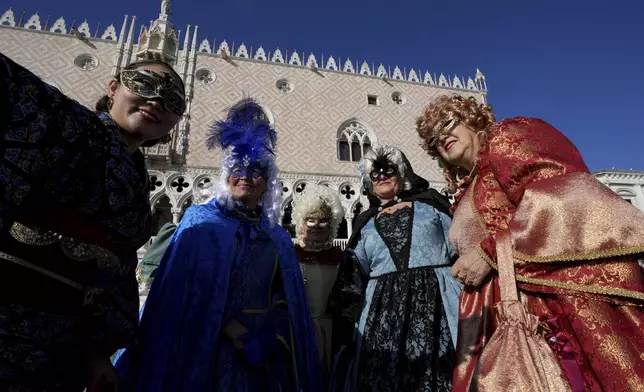 Revellers participate in the celebrations of the historic Venetian Carnival, in St. Mark's Square, Venice, Italy, Saturday, Feb. 15, 2025. (AP Photo/Antonio Calanni)