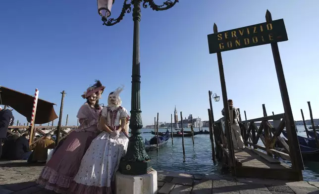 Revellers participate in the celebrations of the historic Venetian Carnival, in St. Mark's Square in Venice, Italy, Saturday, Feb. 15, 2025. (AP Photo/Antonio Calanni)