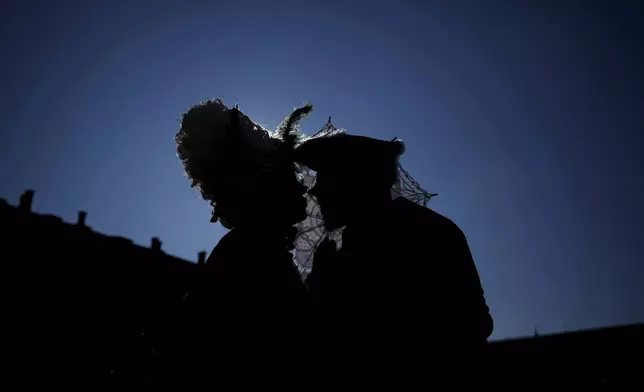 Revellers participate in the celebrations of the historic Venetian Carnival in St. Mark's Square, Venice, Italy, Saturday, Feb. 15, 2025. (AP Photo/Antonio Calanni)