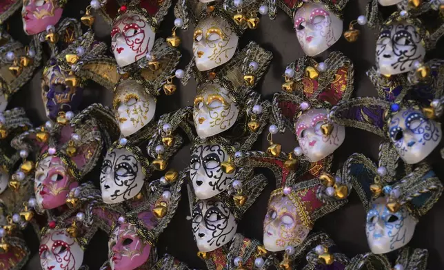 Carnival masks on sale during the Venetian historical carnival in St. Mark's Square, Venice, Italy, Saturday, Feb. 15, 2025. (AP Photo/Antonio Calanni)
