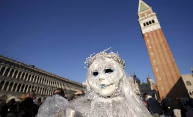 Revellers participate in the celebrations of the historic Venetian Carnival, in St. Mark's Square, Venice, Italy, Saturday, Feb. 15, 2025. (AP Photo/Antonio Calanni)