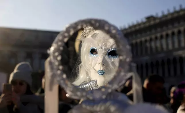 Revellers participate in the celebrations of the historic Venetian Carnival, in St. Mark's Square, Venice, Italy, Saturday, Feb. 15, 2025. (AP Photo/Antonio Calanni)