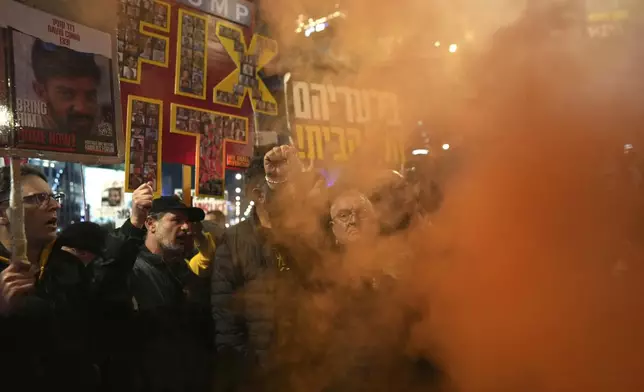 Relatives of hostages, held by Hamas in the Gaza Strip, protest in Tel Aviv, Monday, Feb. 10, 2025 after the militant group announced it would delay hostage releases in the Gaza Strip after accusing Israel of violating a fragile ceasefire. (AP Photo/Ohad Zwigenberg)