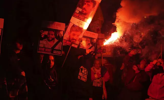 Relatives of hostages, held by Hamas in the Gaza Strip, protest outside of Israel's Ministry of Defense in Tel Aviv, Monday, Feb. 10, 2025, after the militant group announced it would delay hostage releases in the Gaza Strip after accusing Israel of violating a fragile ceasefire. (AP Photo/Ohad Zwigenberg)