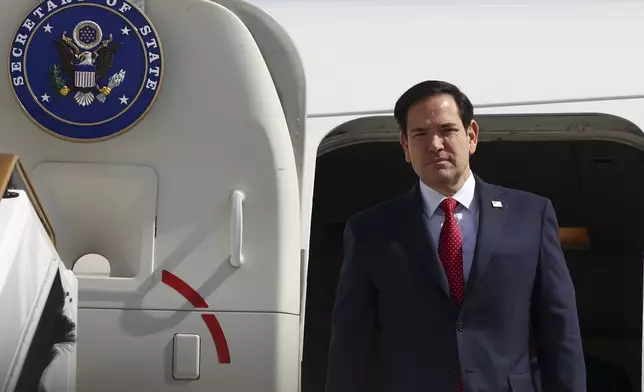 U.S. Secretary of State Marco Rubio disembarks from an aircraft, in Abu Dhabi, United Arab Emirates, Wednesday, Feb. 19, 2025. (Evelyn Hockstein/Pool Photo via AP)