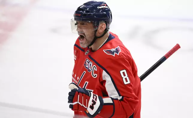 Washington Capitals left wing Alex Ovechkin celebrates his goal during the third period of an NHL hockey game against the Calgary Flames as he skates towards the bench, Tuesday, Feb. 25, 2025, in Washington. (AP Photo/Nick Wass)
