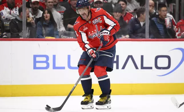 Washington Capitals left wing Alex Ovechkin passes the puck during the second period of an NHL hockey game against the Calgary Flames, Tuesday, Feb. 25, 2025, in Washington. (AP Photo/Nick Wass)