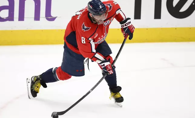 Washington Capitals left wing Alex Ovechkin winds up for a shot during the third period of an NHL hockey game against the Calgary Flames, Tuesday, Feb. 25, 2025, in Washington. (AP Photo/Nick Wass)