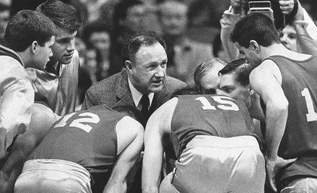 FILE - Actor Gene Hackman gives fictional Hickory High basketball players instructions during filming of the final game of the movie "Hoosiers" at Hinkle Fieldhouse on the Butler University campus, Friday, Dec. 6, 1985 in Indianapolis. (AP Photo/Tom Strickland, File)