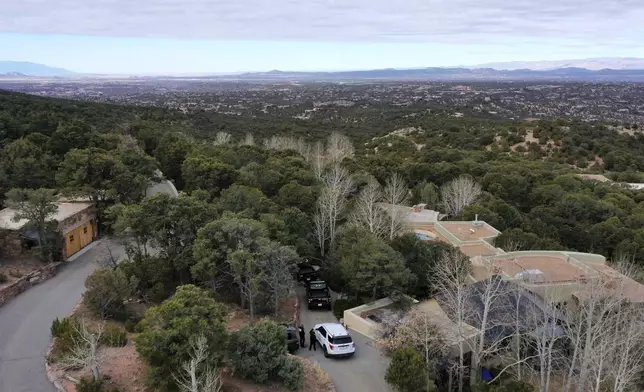 Law enforcement officials talk outside the home of actor Gene Hackman on Thursday, Feb. 27, 2025. Hackman, his wife Betsy Arakawa and their wife were found dead in the home a day earlier. (AP Photo/Roberto Rosales)