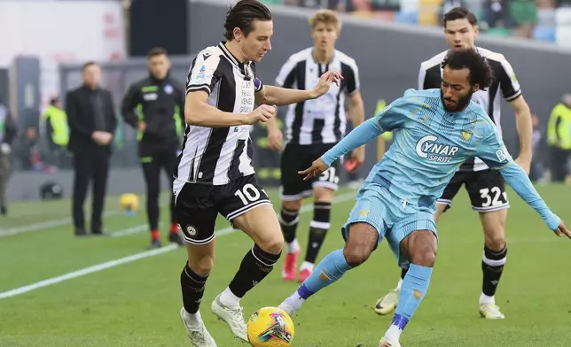 Udinese's Florian Thauvin, left, and Venezia's Gianluca Busio vie for the ball during the Serie A soccer match between Udinese and Venezia at the Bluenergy Stadium in Udine, Italy, Saturday, Feb. 1, 2025. (Andrea Bressanutti/LaPresse via AP)