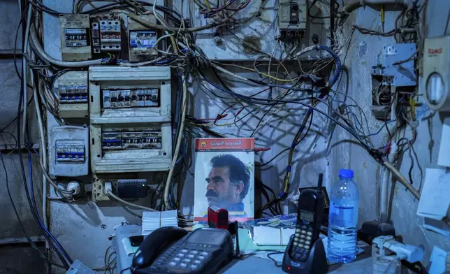 A picture Abdullah Ocalan, the imprisoned leader of Turkey's banned Kurdistan Workers' Party, or PKK, is displayed inside a petrol station in the northeastern Syrian city of Qamishli, Sunday, Jan. 26, 2025. (AP Photo/Bernat Armangue)