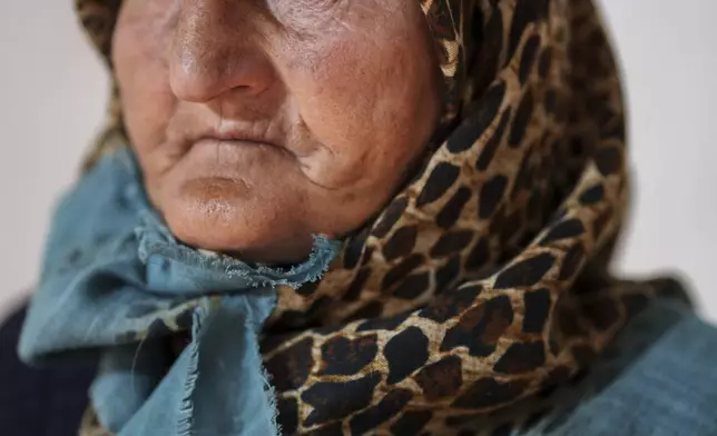Goulieh Adbu, 70, who is internally displaced, poses for a portrait at an old school used as a temporary shelter in the northeastern Syrian city of Qamishli, which is controlled by the U.S.-backed, Kurdish-led Syrian Democratic Forces, Tuesday, Jan. 28, 2025. (AP Photo/Bernat Armangue)
