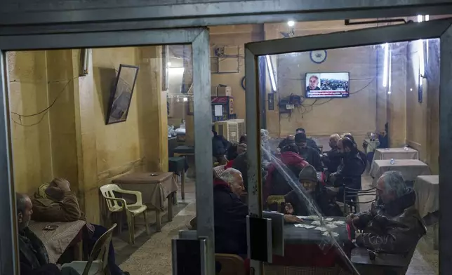 Men play cards at a coffee shop in the northeastern Syrian city of Qamishli, which is controlled by the U.S.-backed, Kurdish-led Syrian Democratic Forces, Tuesday, Jan. 28, 2025. (AP Photo/Bernat Armangue)