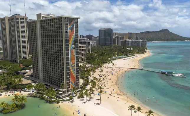 The Rainbow Tower of the Hilton Hawaiian Village Waikiki Beach Resort is seen on Thursday, Aug. 22, 2024, in Honolulu. The iconic 31-story Rainbow Mural was designed by artist Millard Sheets in 1968. (AP Photo/Mengshin Lin)
