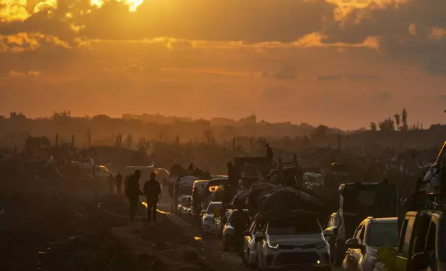 Displaced Palestinians, traveling in vehicles, wait in line to pass through a security checkpoint at the Netzarim corridor as they make their way from central Gaza to their homes in the northern Gaza Strip, Monday, Feb. 10, 2025. (AP Photo/Abdel Kareem Hana)