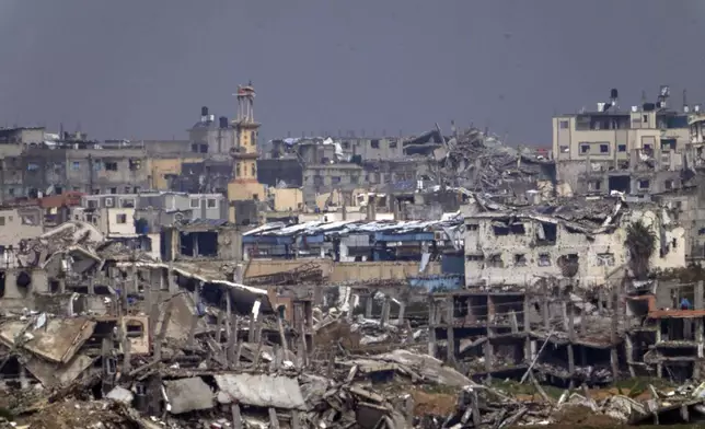 Destroyed buildings by Israeli bombardments inside the northern Gaza Strip as seen from southern Israel, Tuesday, Feb.11, 2025. (AP Photo/Ariel Schalit)