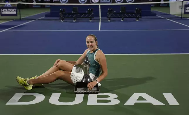 Russia's Mirra Andreeva holds the winner's trophy after the Dubai Duty-Free Tennis Championship final match in Dubai, United Arab Emirates, on Saturday, Feb. 22, 2025. (AP Photo/Altaf Qadri)