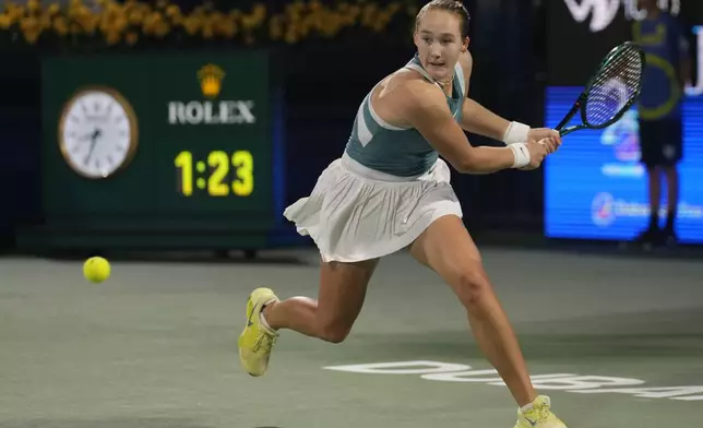Russia's Mirra Andreeva returns to Denmark's Clara Tauson during the Dubai Duty Free Tennis Championship final match in Dubai, United Arab Emirates, on Saturday, Feb. 22, 2025. (AP Photo/Altaf Qadri)