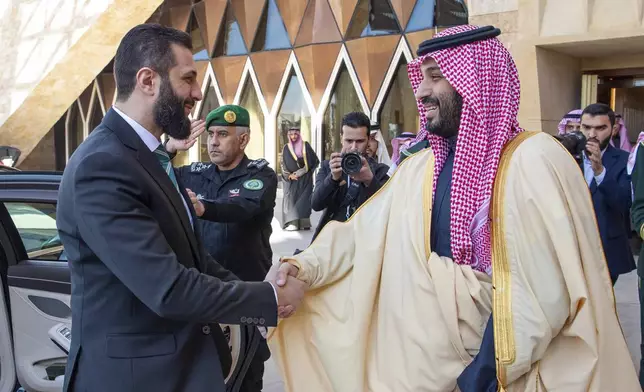 In this photo provided by the Saudi Ministry of Media, Saudi Crown Prince Mohammed bin Salman greets Syria's interim President Ahmad al-Sharaa, left, during his arrival at the royal palace in Riyadh, Saudi Arabia, Sunday, Feb. 2, 2025. (Saudi Ministry of Media via AP)