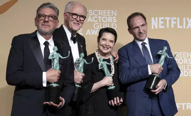 Sergio Castellitto, from left, John Lithgow, Isabella Rossellini, and Ralph Fiennes, winners of the award for outstanding performance by a cast in a motion picture for "Conclave," pose in the press room during the 31st annual Screen Actors Guild Awards on Sunday, Feb. 23, 2025, at the Shrine Auditorium in Los Angeles. (Photo by Jordan Strauss/Invision/AP)