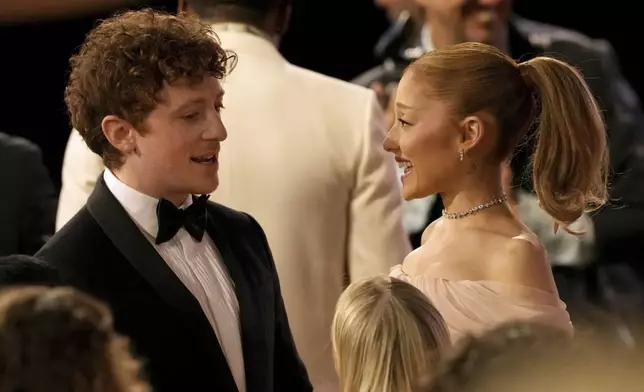 Ethan Slater, left, talks with Ariana Grande during the 31st annual Screen Actors Guild Awards on Sunday, Feb. 23, 2025, at the Shrine Auditorium in Los Angeles. (AP Photo/Chris Pizzello)