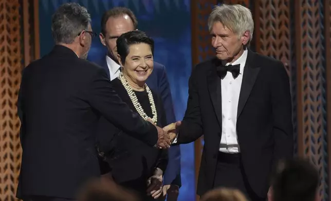 Harrison Ford, far right, presents the award for outstanding performance by a cast in a motion picture to Sergio Castellitto, far left, and Isabella Rossellini during the 31st annual Screen Actors Guild Awards on Sunday, Feb. 23, 2025, at the Shrine Auditorium in Los Angeles. (AP Photo/Chris Pizzello)