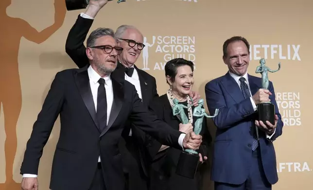 Sergio Castellitto, from left, John Lithgow, Isabella Rossellini, and Ralph Fiennes, winners of the award for outstanding performance by a cast in a motion picture for "Conclave," pose in the press room during the 31st annual Screen Actors Guild Awards on Sunday, Feb. 23, 2025, at the Shrine Auditorium in Los Angeles. (Photo by Jordan Strauss/Invision/AP)