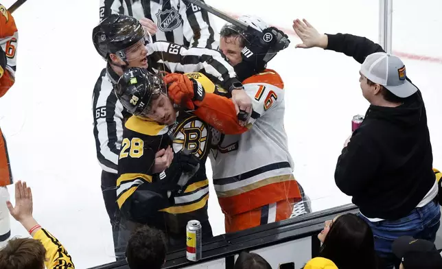 Boston Bruins center Elias Lindholm (28) and Anaheim Ducks center Ryan Strome (16) fight during the first period of an NHL hockey game, Saturday, Feb. 22, 2025, in Boston. (AP Photo/Mary Schwalm)