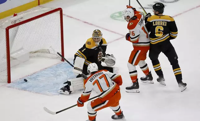 Anaheim Ducks right wing Frank Vatrano (77) scores past Boston Bruins goaltender Jeremy Swayman (1) during the first period of an NHL hockey game, Saturday, Feb. 22, 2025, in Boston. (AP Photo/Mary Schwalm)