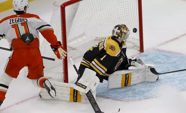 Anaheim Ducks center Trevor Zegras (11) scores past Boston Bruins goaltender Jeremy Swayman (1) during the first period of an NHL hockey game, Saturday, Feb. 22, 2025, in Boston. (AP Photo/Mary Schwalm)
