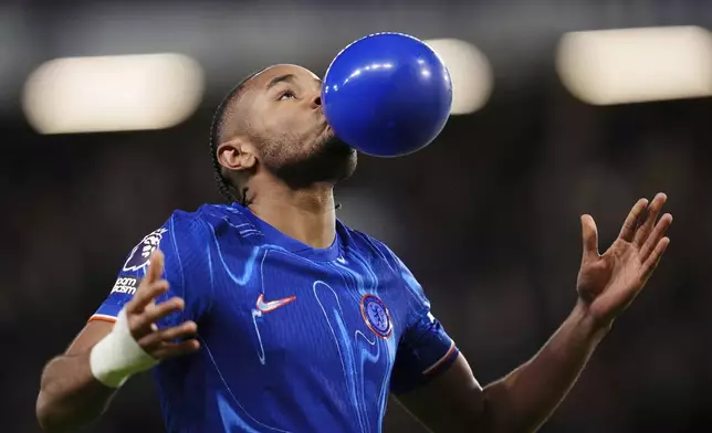 Chelsea's Christopher Nkunku celebrates scoring their side's first goal of the game during the English Premier League soccer match between Chelsea and Southampton at Stamford Bridge, London, Tuesday, Feb. 25, 2025. (John Walton/PA via AP)