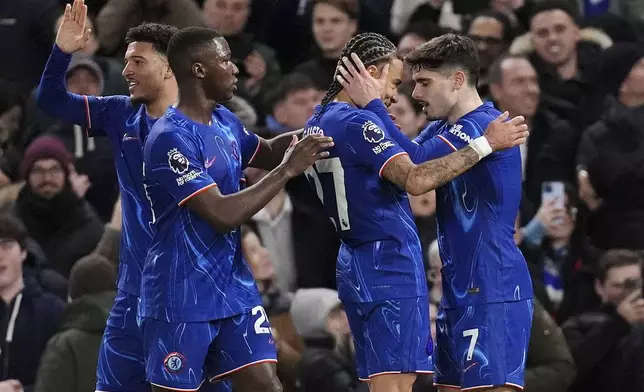 Chelsea's Pedro Neto, right, celebrates with teammates after scoring their side's second goal of the game during the English Premier League soccer match between Chelsea and Southampton at Stamford Bridge, London, Tuesday, Feb. 25, 2025. (John Walton/PA via AP)