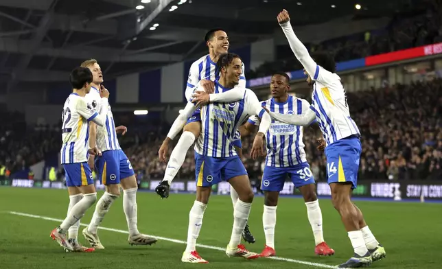 Brighton and Hove Albion's Joao Pedro, center, celebrates scoring his side's first goal of the game with team-mates during the English Premier League soccer match between Brighton and Hove Albion and AFC Bournemouth, at American Express Stadium, Brighton, England, Tuesday Feb. 25, 2025. (Steven Paston/PA via AP)