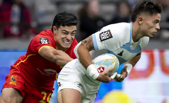 Spain's Anton Legorburu, left, chases Argentina's Marcos Moneta, right, during a Vancouver Sevens semifinal rugby match in Vancouver, British Columbia, Sunday, Feb. 23, 2025. (Ethan Cairns/The Canadian Press via AP)