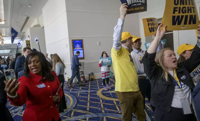 Supporters and volunteers of DNC chair candidate Ben Wikler cheer outside of the ballroom in the hours prior to the votes for positions at the Democratic National Committee Winter Meeting at the Gaylord National Resort and Convention Center in National Harbor, Md., Saturday, Feb. 1, 2025. (AP Photo/Rod Lamkey, Jr.)
