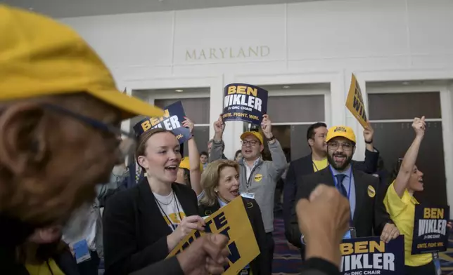 Supporters of DNC chair candidate Ben Wikler rally outside of the ballroom in the hours prior to the votes for positions at the Democratic National Committee Winter Meeting at the Gaylord National Resort and Convention Center in National Harbor, Md., Saturday, Feb. 1, 2025. (AP Photo/Rod Lamkey, Jr.)