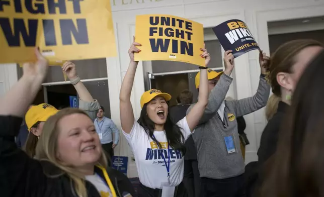Supporters of DNC chair candidate Ben Wikler rally outside of the ballroom in the hours prior to the votes for positions at the Democratic National Committee Winter Meeting at the Gaylord National Resort and Convention Center in National Harbor, Md., Saturday, Feb. 1, 2025. (AP Photo/Rod Lamkey, Jr.)