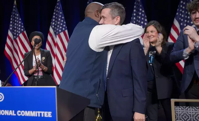 Former Democratic National Committe Chairman Jamie Harrison, left, congratulates newly elected DNC Chairman Ken Martin, right, after Martin won the vote at the Democratic National Committee Winter Meeting at the Gaylord National Resort and Convention Center in National Harbor, Md., Saturday, Feb. 1, 2025. (AP Photo/Rod Lamkey, Jr.)
