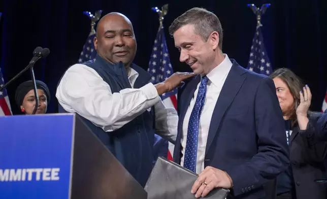 Former Democratic National Committe Chairman Jamie Harrison, left, congratulates newly elected DNC Chairman Ken Martin, right, after Martin won the vote at the Democratic National Committee Winter Meeting at the Gaylord National Resort and Convention Center in National Harbor, Md., Saturday, Feb. 1, 2025. (AP Photo/Rod Lamkey, Jr.)