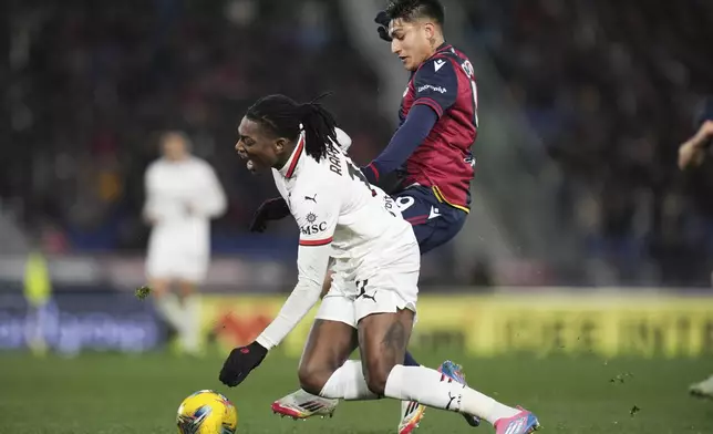 AC Milan's Rafael Leao, left, and Bologna's Santiago Castro in action during the Serie A soccer match between Bologna FC and A.C. Milan at Renato Dall'Ara Stadium, Bologna, Italy, Thursday, Feb. 27, 2025. (Michele Nucci/LaPresse via AP)