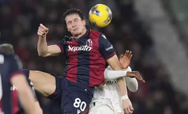 Bologna's Lorenzo De Silvestri, left, and AC Milan's Youssouf Fofana in action during the Serie A soccer match between Bologna FC and A.C. Milan at Renato Dall'Ara Stadium, Bologna, Italy, Thursday, Feb. 27, 2025. (Michele Nucci/LaPresse via AP)