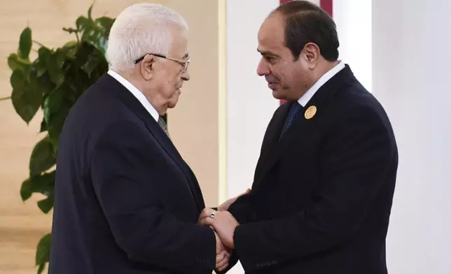 In this photo provided by Egypt's presidency media office, Egyptian President Abdel-Fattah el-Sissi, greets Palestinian Authority President Mahmoud Abbas, during the emergency Arab summit at Egypt's New Administrative Capital, just outside Cairo, Tuesday, March 4, 2025. (Egyptian Presidency Media Office via AP)