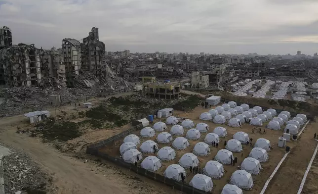 A tent camp for displaced Palestinians is set up amid destroyed buildings in the west of Al-Shati camp, west of Gaza City, on Monday, March 3, 2025. (AP Photo/Jehad Alshrafi)
