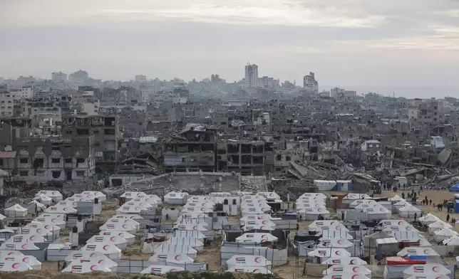 A tent camp for displaced Palestinians is set up amid destroyed buildings in the west of Al-Shati camp, west of Gaza City, on Monday, March 3, 2025. (AP Photo/Jehad Alshrafi)