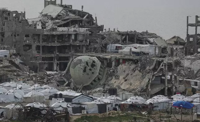 A tent camp for displaced Palestinians is set up amid destroyed buildings in the west of Al-Shati camp, west of Gaza City, on Monday, March 3, 2025. (AP Photo/Jehad Alshrafi)